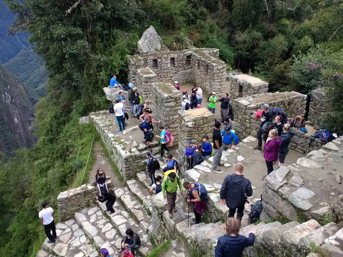 Visitors gathered at Inti Punku, the Sun Gate above Machu Picchu, Peru
